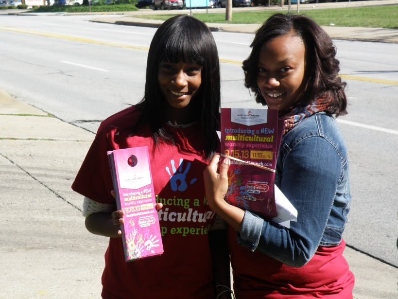 Girls go into community with door signs announcing the satellite lauch