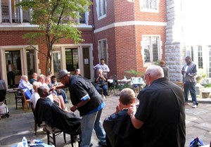 Beauty services given to people in need. Setting is outdoor common area.