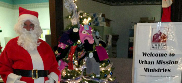 Santa welcomes, Urban Mission signage