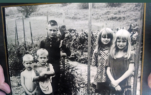 Black and white photo of children in garden