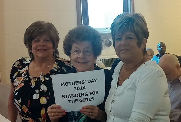 Fran and Daughters hold up sign
