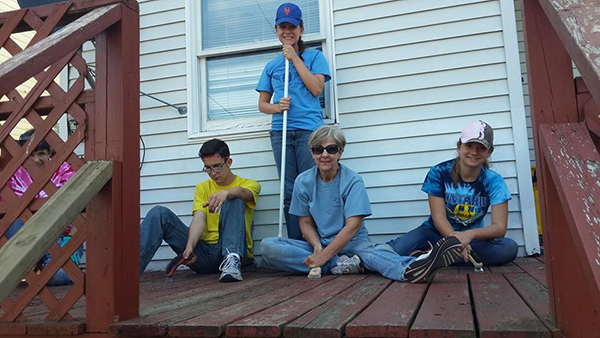 SOWER workers sit and stand on deck 