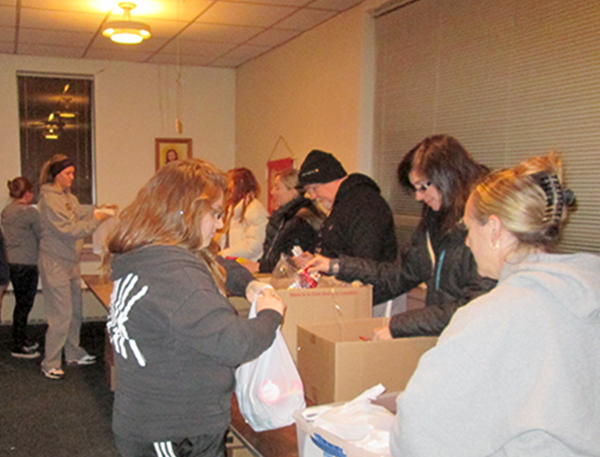 Pastor Dick Smith and Brookfield UMC  members packing supplies for Brookfield Backpack Charitable Fund. 