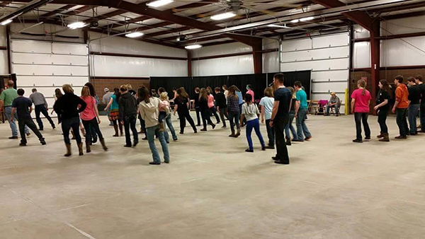 Large group of teens standing in building