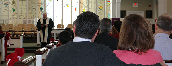 Couple in pew listening to Rev. Clark Stein