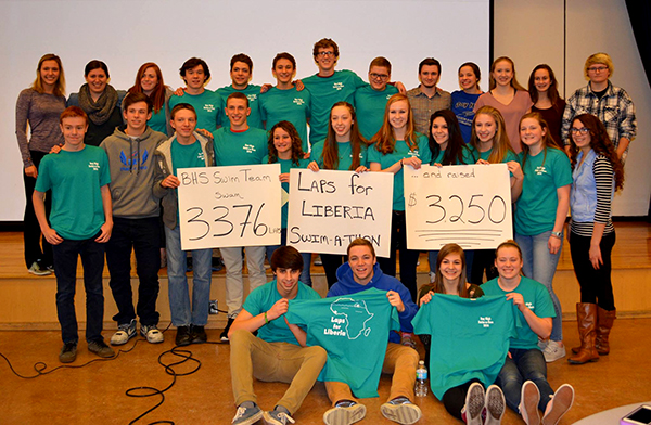 HIgh School Students holsd signs and t-shirts