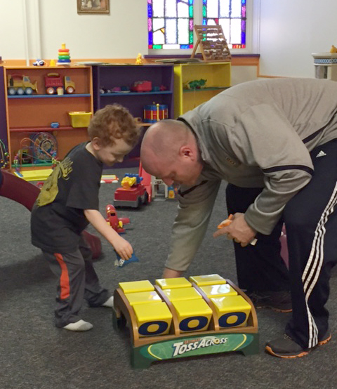 Man playing with toddler