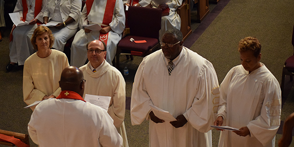 New bishops standing before Bishop Palmer