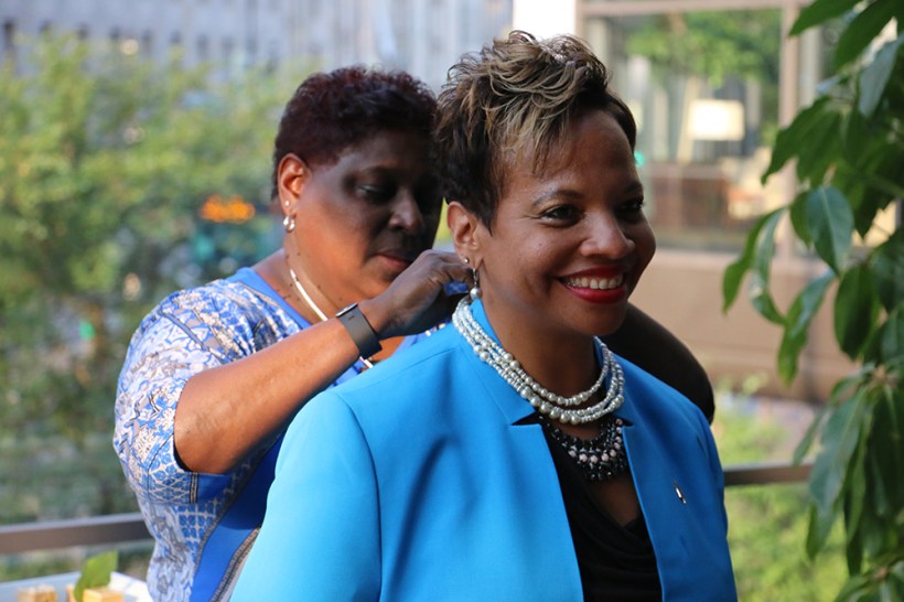 Bishop Tracy S. Malone receives a string of pearls from the Rev. Danita Anderson