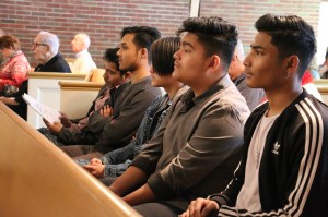 Butanese and Grandview members sit in pews