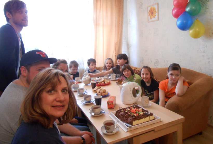 Ukraine children at a table with mission team