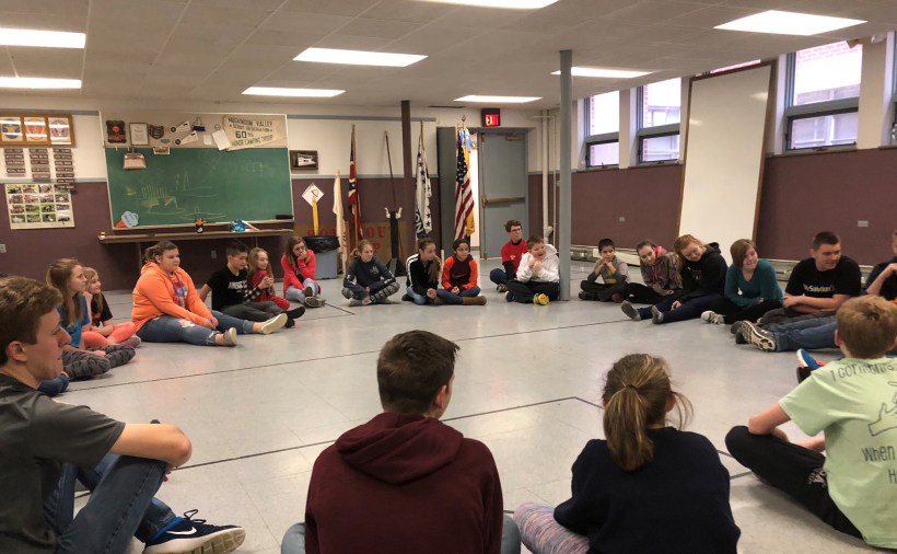 Youth seated in large circle