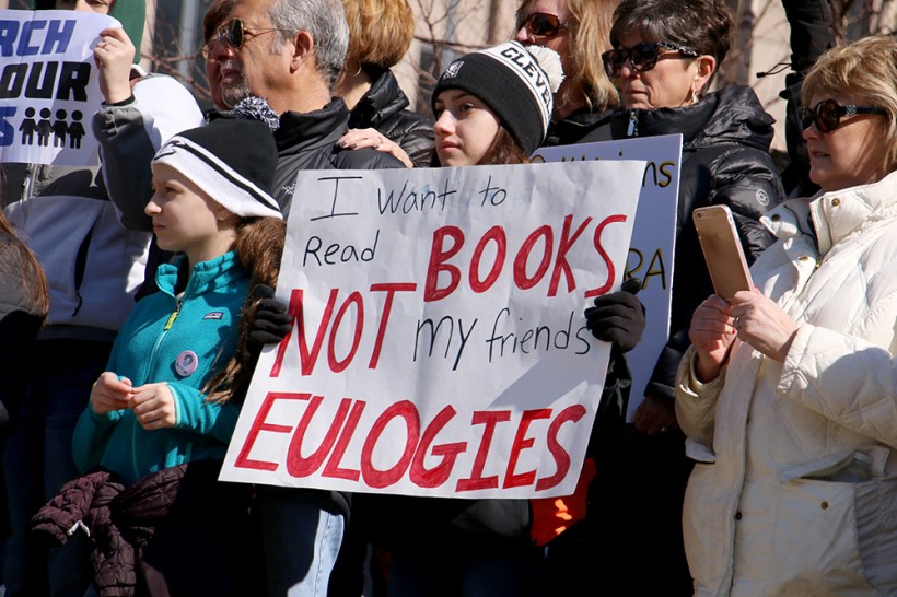 A student makes her feelings known at the Cleveland rally with a sign that reads. "I want to read books not my friends' eulogies."