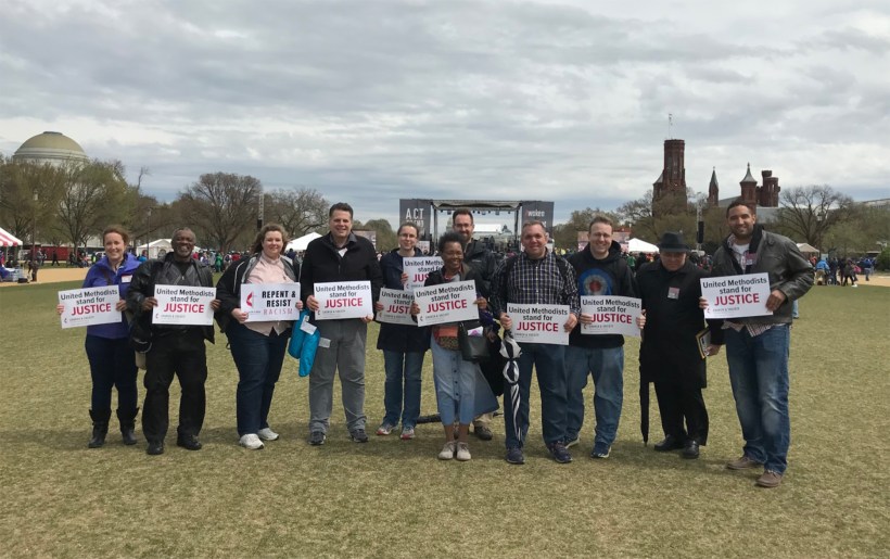 East Ohioans hold up signs