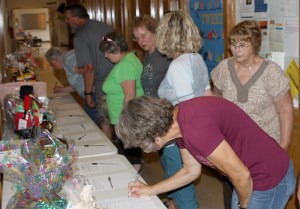 people signing up for raffle tickest and auction