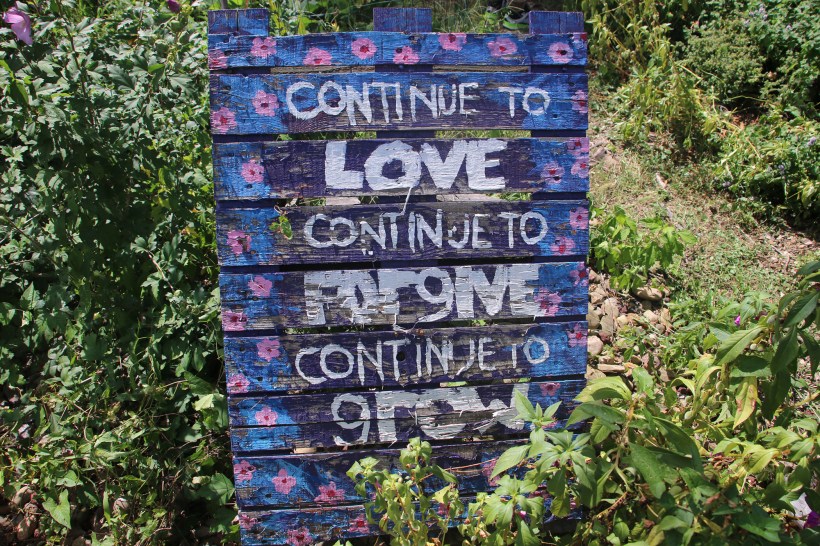 Sing in garden reads "continue to love continue to forgive continue to grow
