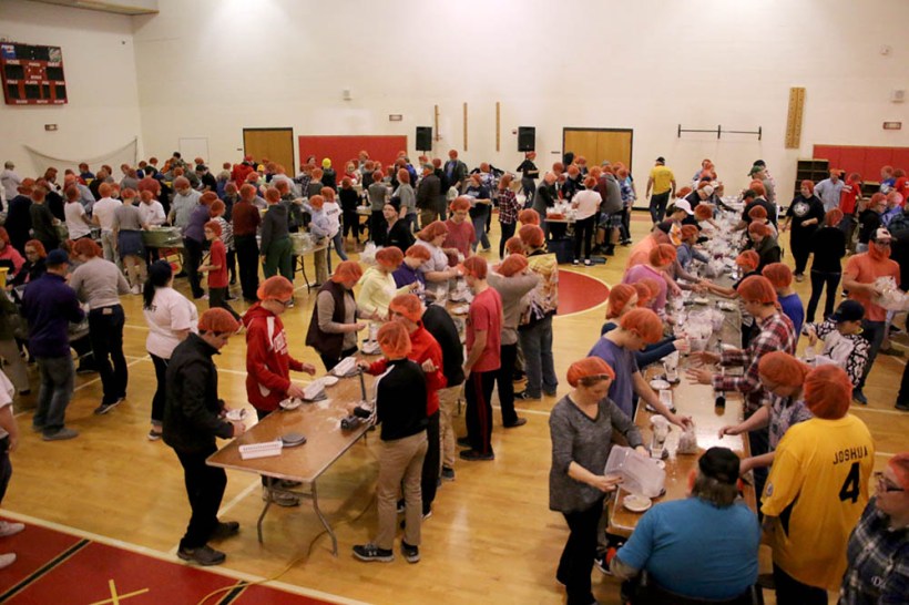 Full view of youth packing meals